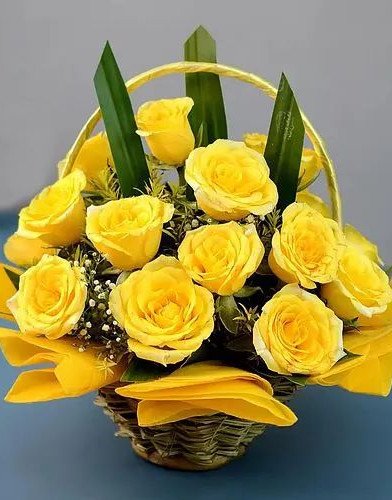 Cheerful Basket of Sun kissed Yellow Roses with Greens